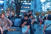 City skyline with people using digital devices outdoors