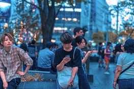 Vibrant town square with people using mobile devices, symbolizing local connectivity.