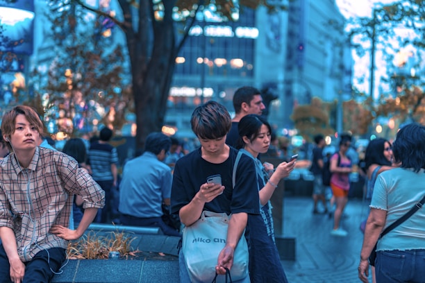 A vibrant city street scene with people reading news on their smartphones.