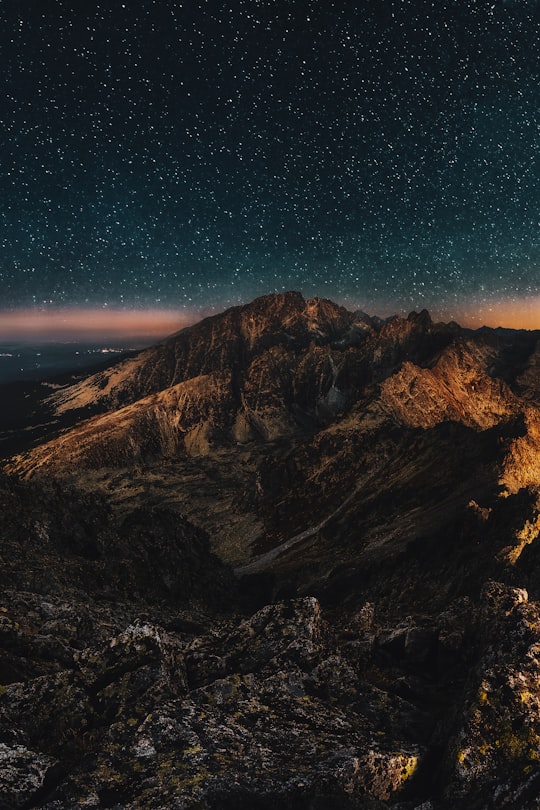 brown mountain under starry night in Dolomites Italy