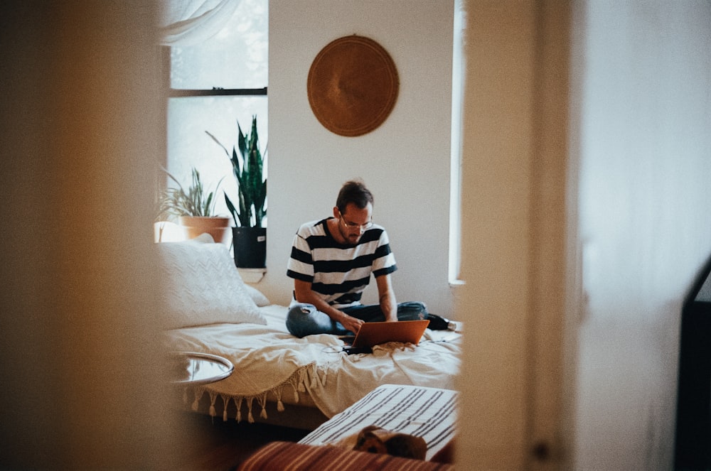 man sitting on bed