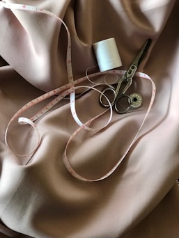 white tape measure and gray scissors