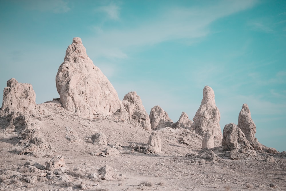 gray and black rock formations under blue and white sky during daytime