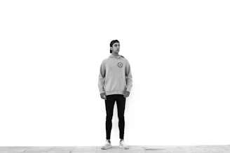 Close-up of a model wearing a soft beige oversized hoodie in a minimalist urban setting.