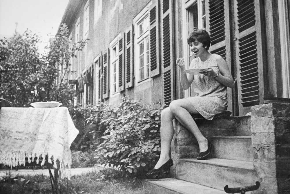 woman sitting beside door