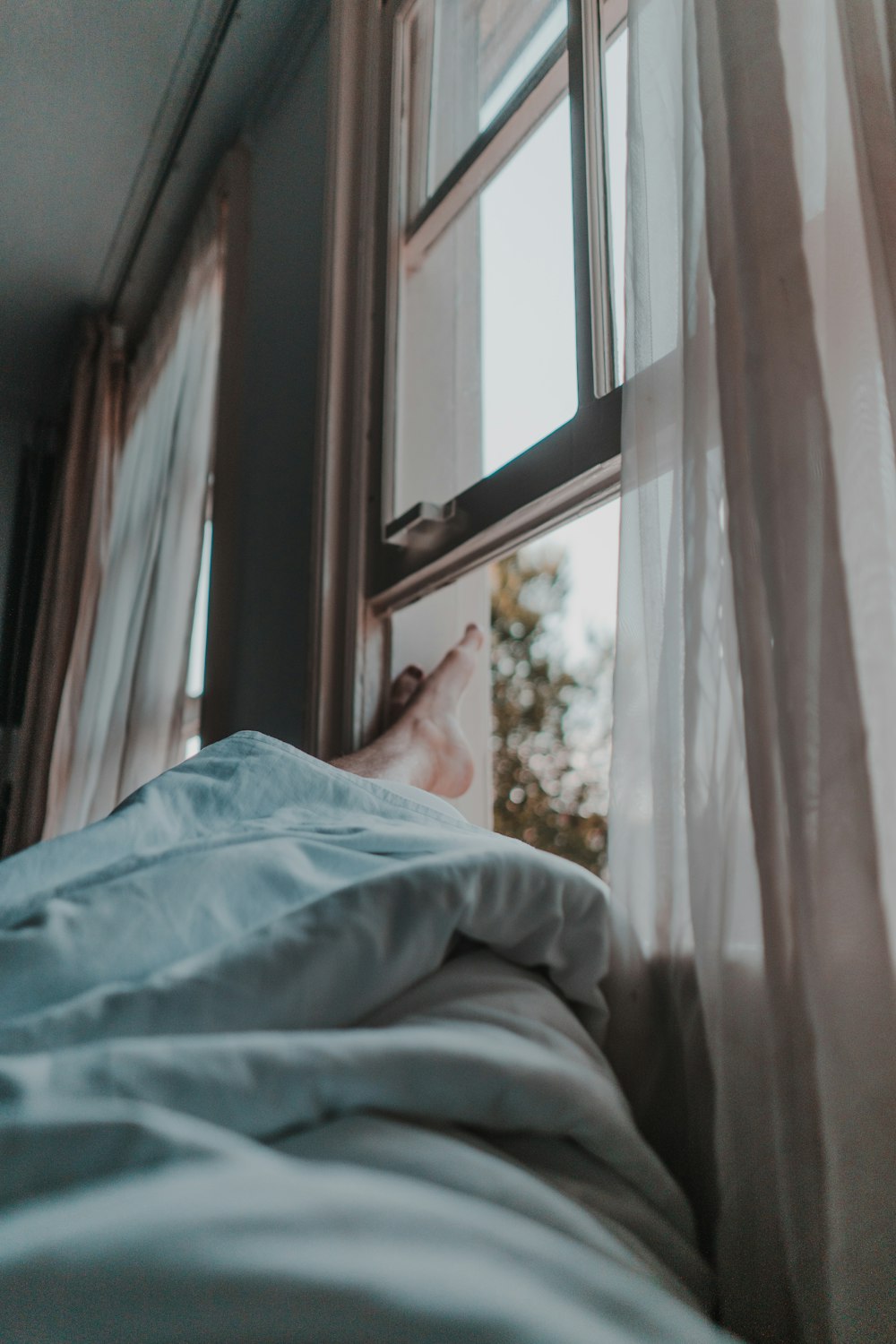 person lying near window