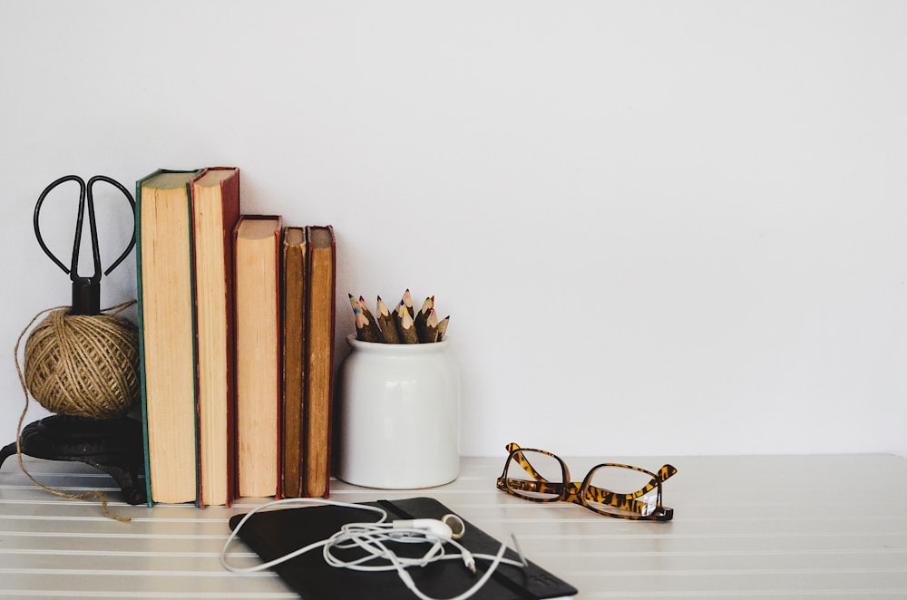 assorted-color pencil lot in white ceramic jar