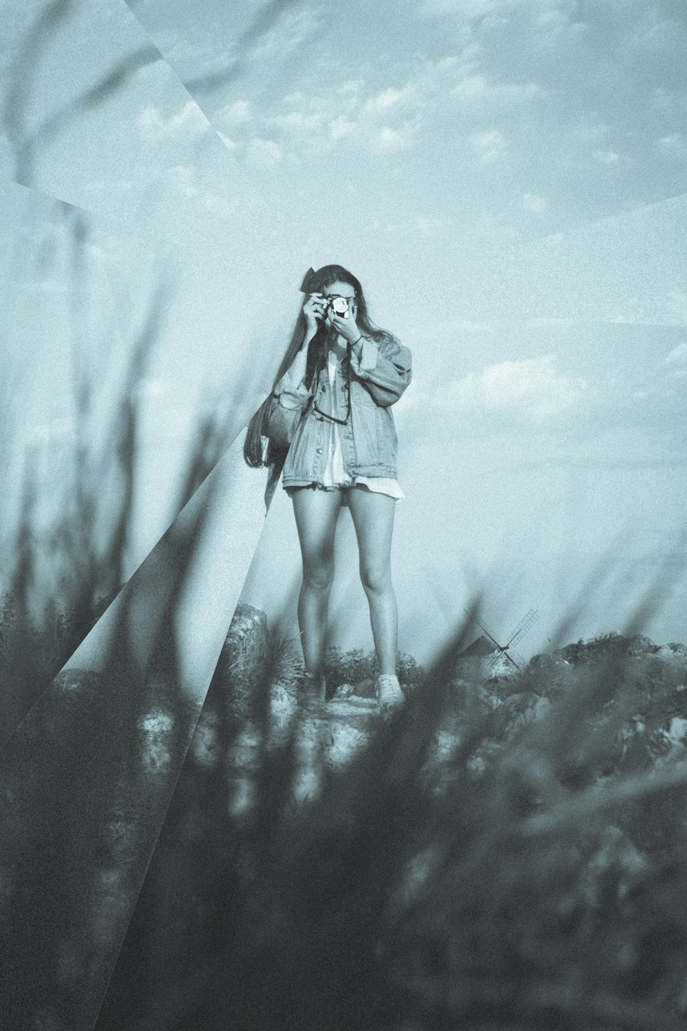 woman taking picture near grass