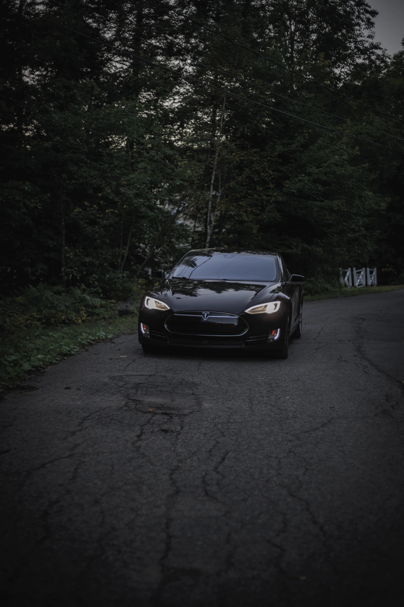 Black Tesla Model S Plaid electric sedan at nighttime