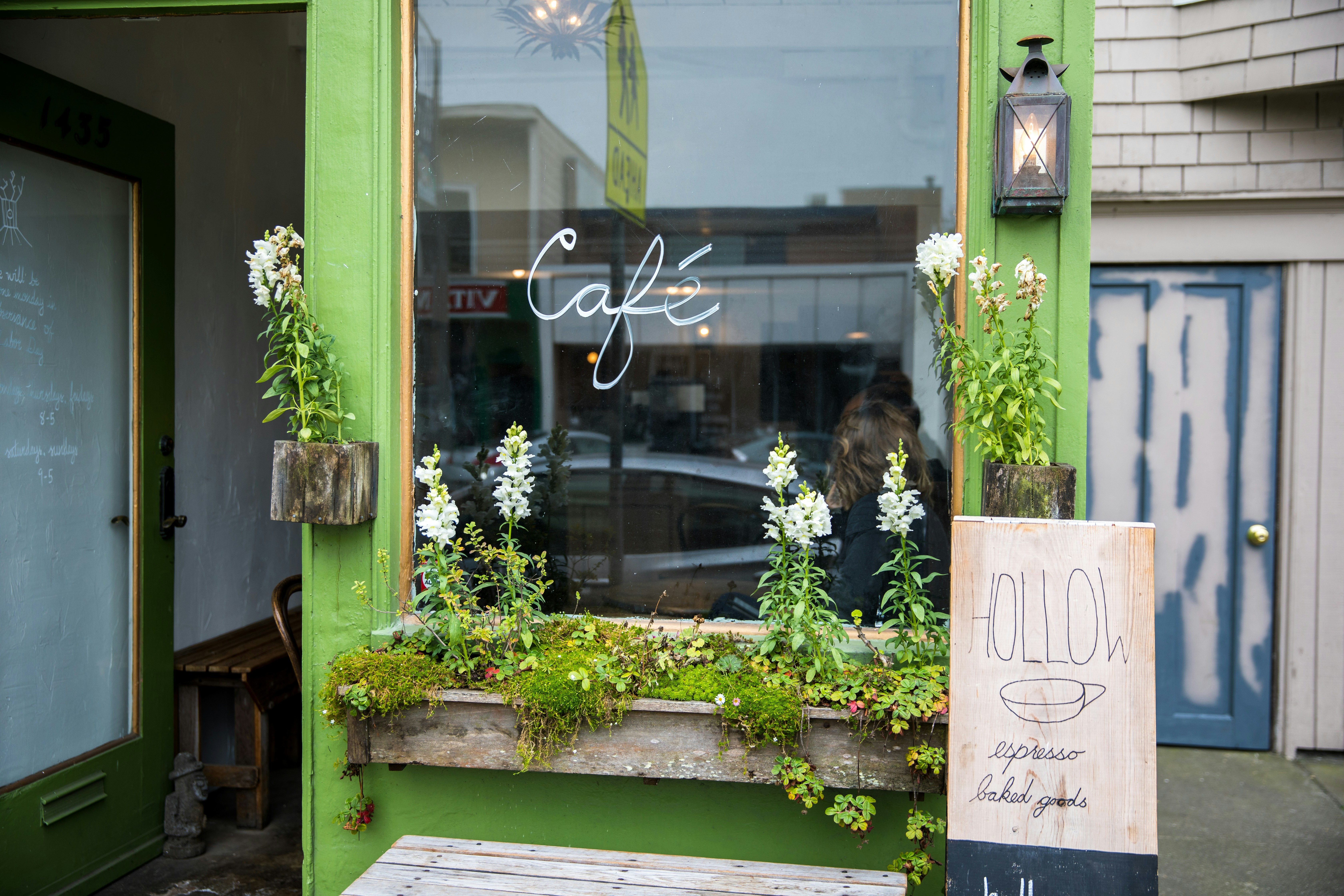 beige Hollow board beside green Cafe glass panel