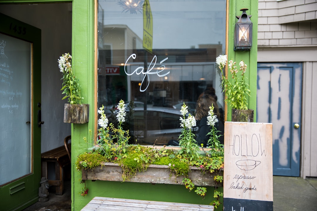beige Hollow board beside green Cafe glass panel