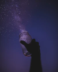 person holding glass jar