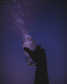 person holding glass jar