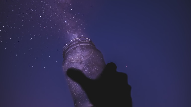 person holding glass jar