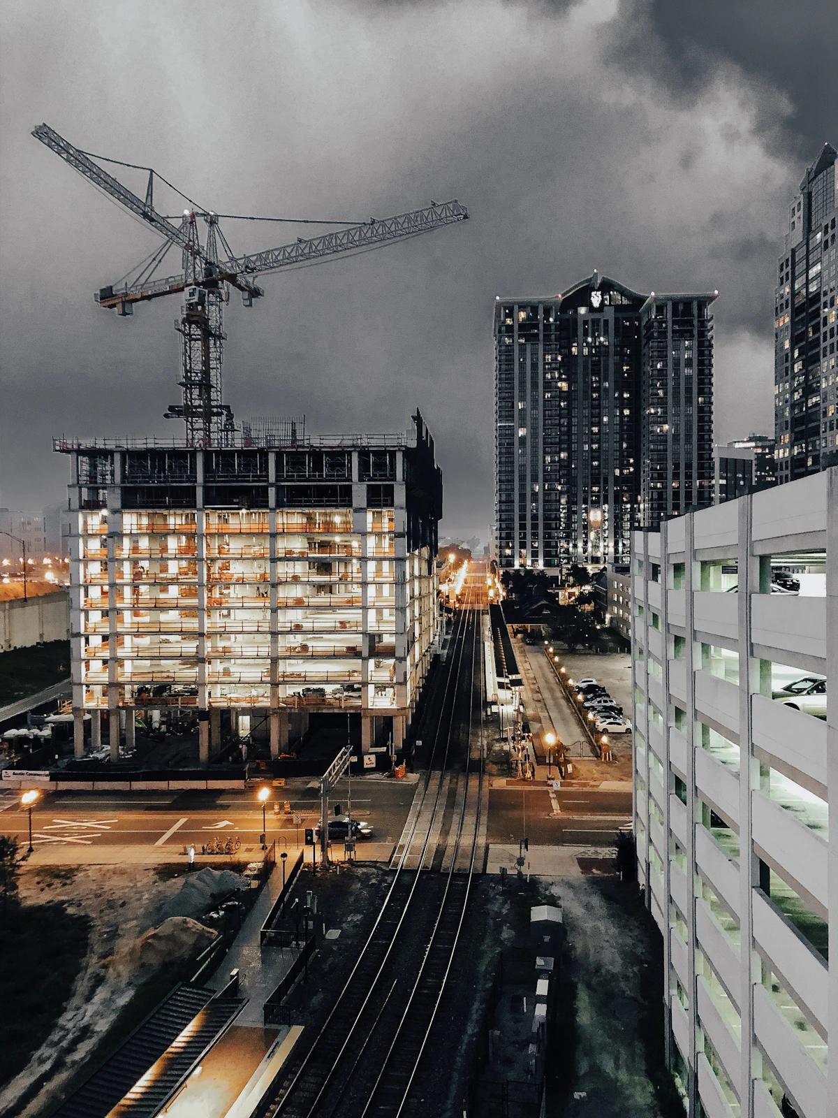 Commercial construction cranes over a mid-sized American city development