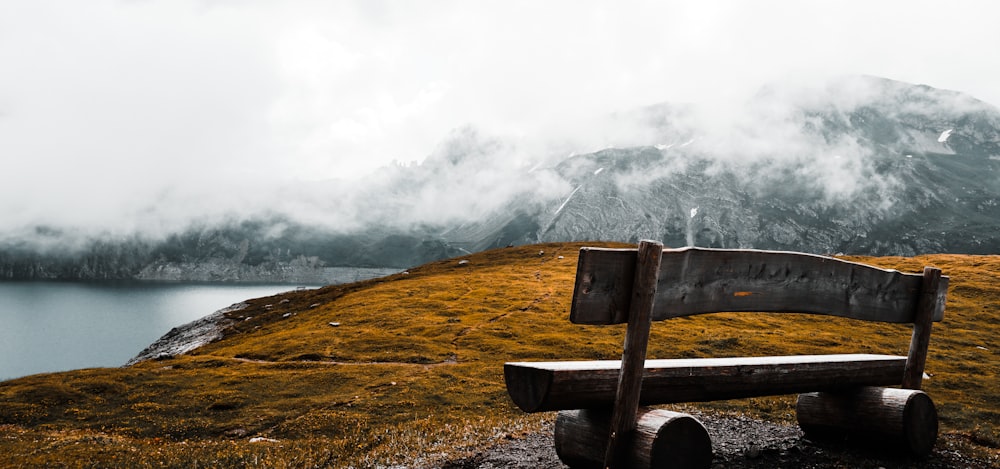 brown wooden bench on cliff