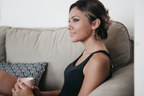 woman leaning on sofa