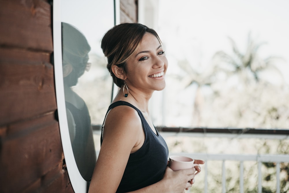 smiling woman in front of window