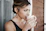 A confident woman reviewing her monthly bills with a warm cup of tea nearby.