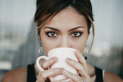 Single women Adelaide — member enjoying a coffee before messaging on AimerWorld