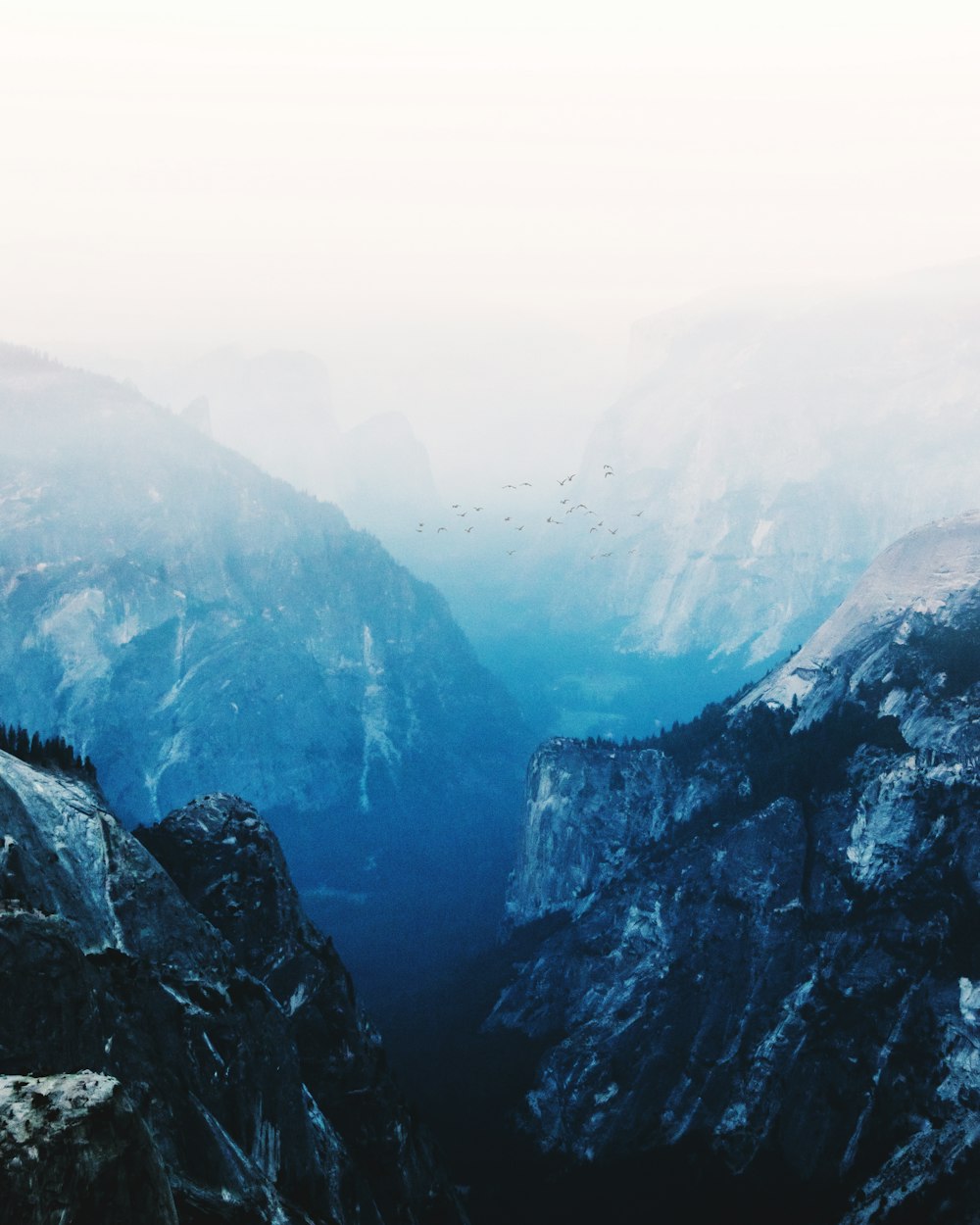 snowy mountain under cloudy sky