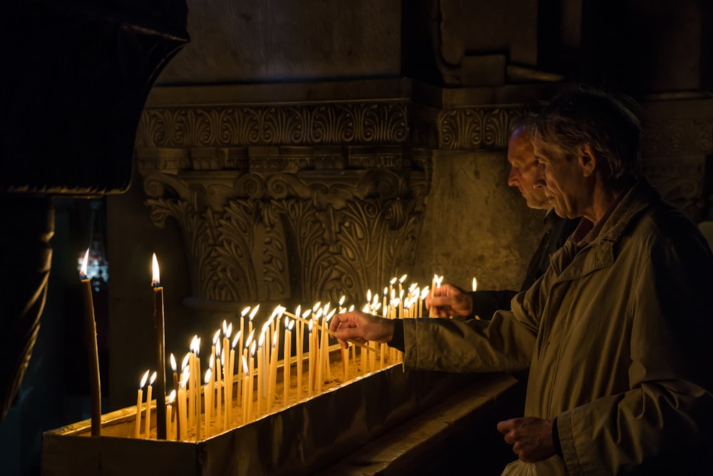 priest lighting up candles