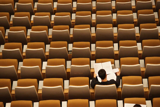 person reading in empty lecture hall