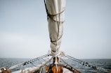 boat on sea under white sky