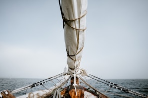 boat on sea under white sky