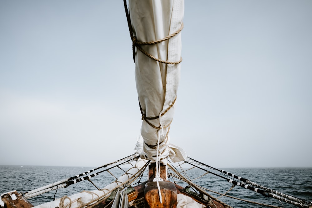 boat on sea under white sky