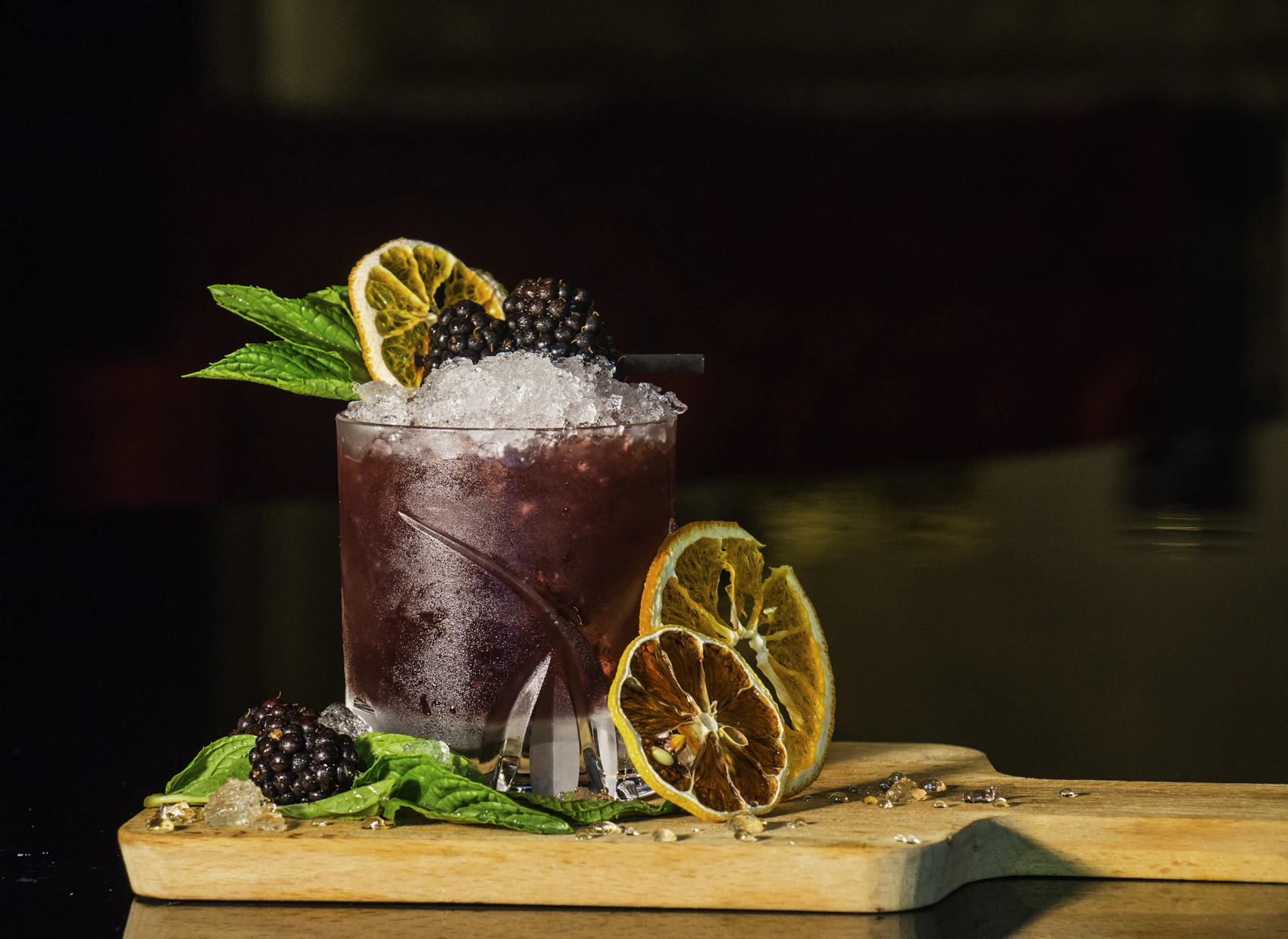 Citrus drink served over ice in elegant glassware