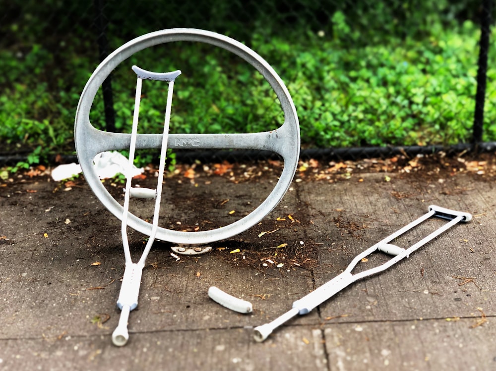 two gray crutches on concrete pavement during daytime