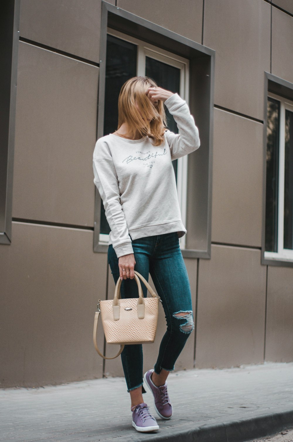 woman standing on holding handbag