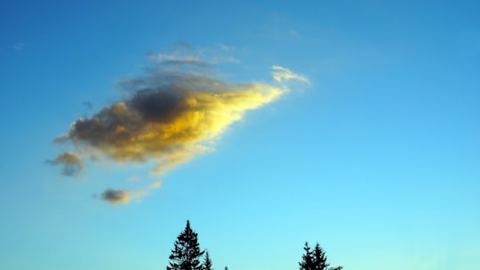 lump of cloud on a clear sky during daytime in Schladming Austria