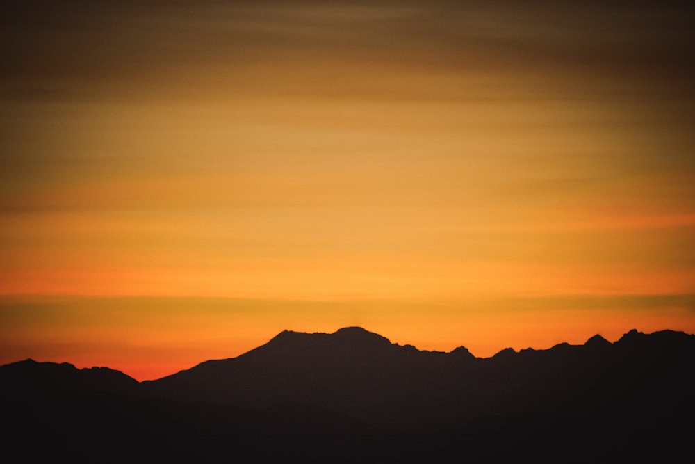 silhouette of mountain during golden hour