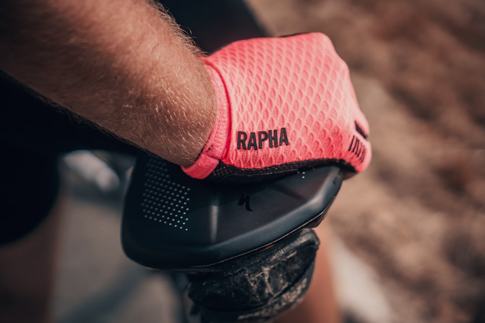 person wearing pink Rapha gloves