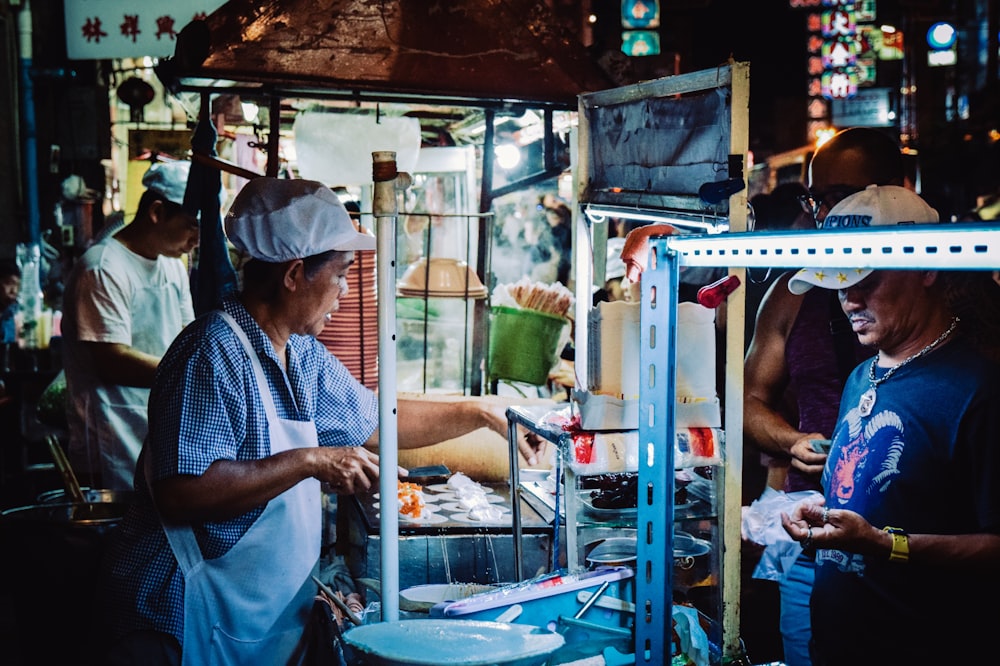 person cooking in kiosk