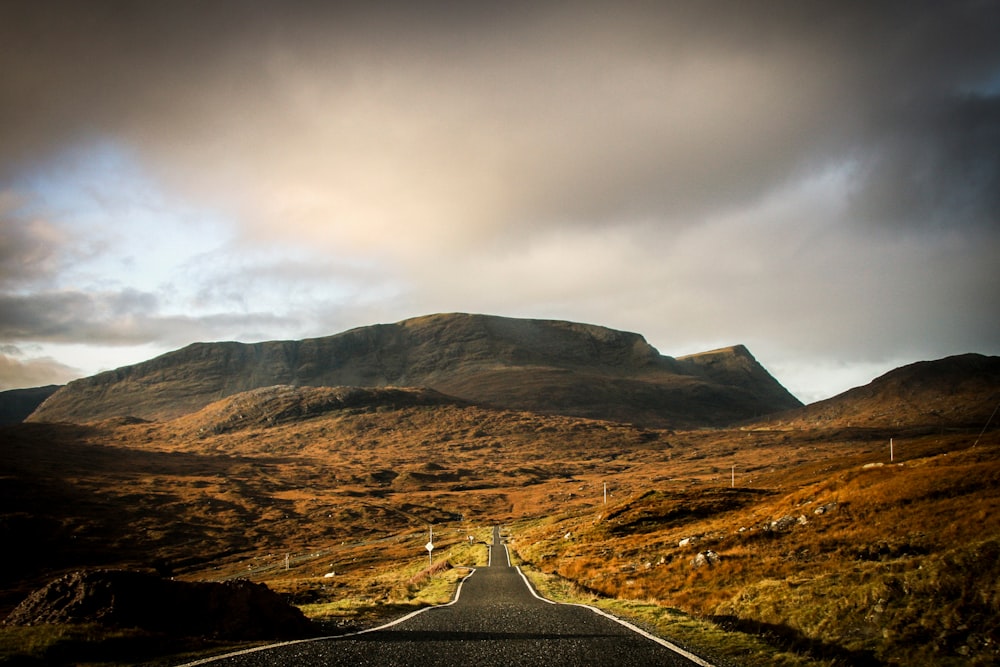 clear roadway and view of mountains