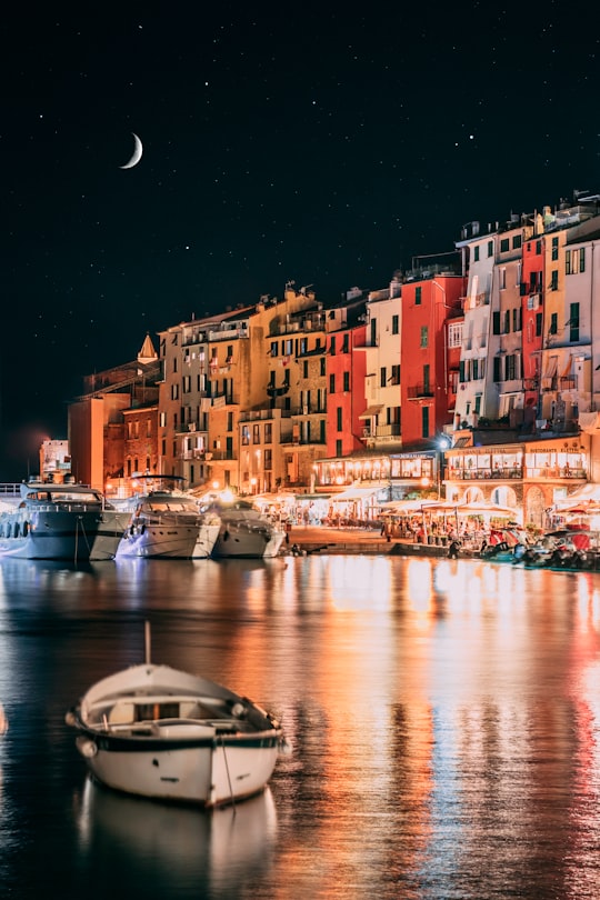 white boat on water during night time in Portovenere Italy