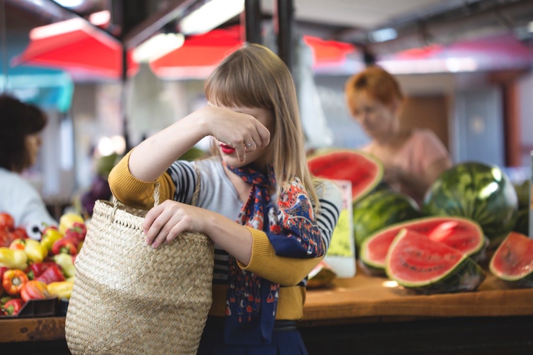 woman carrying woven bag in market