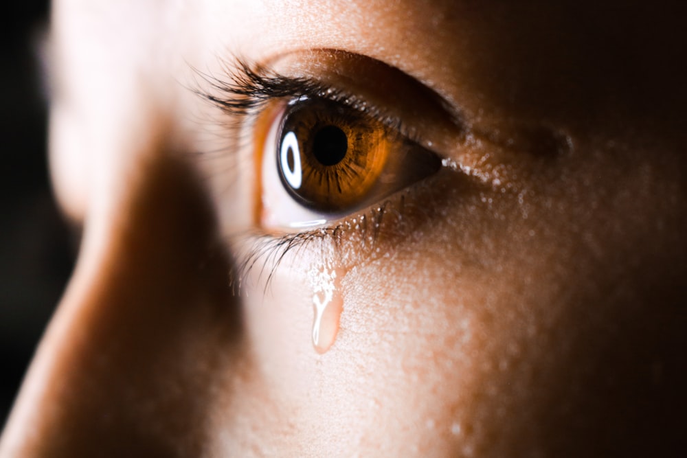 close-up photo of human eye with tear drops