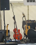 A close-up of acoustic guitars and microphones ready for a live country music show.