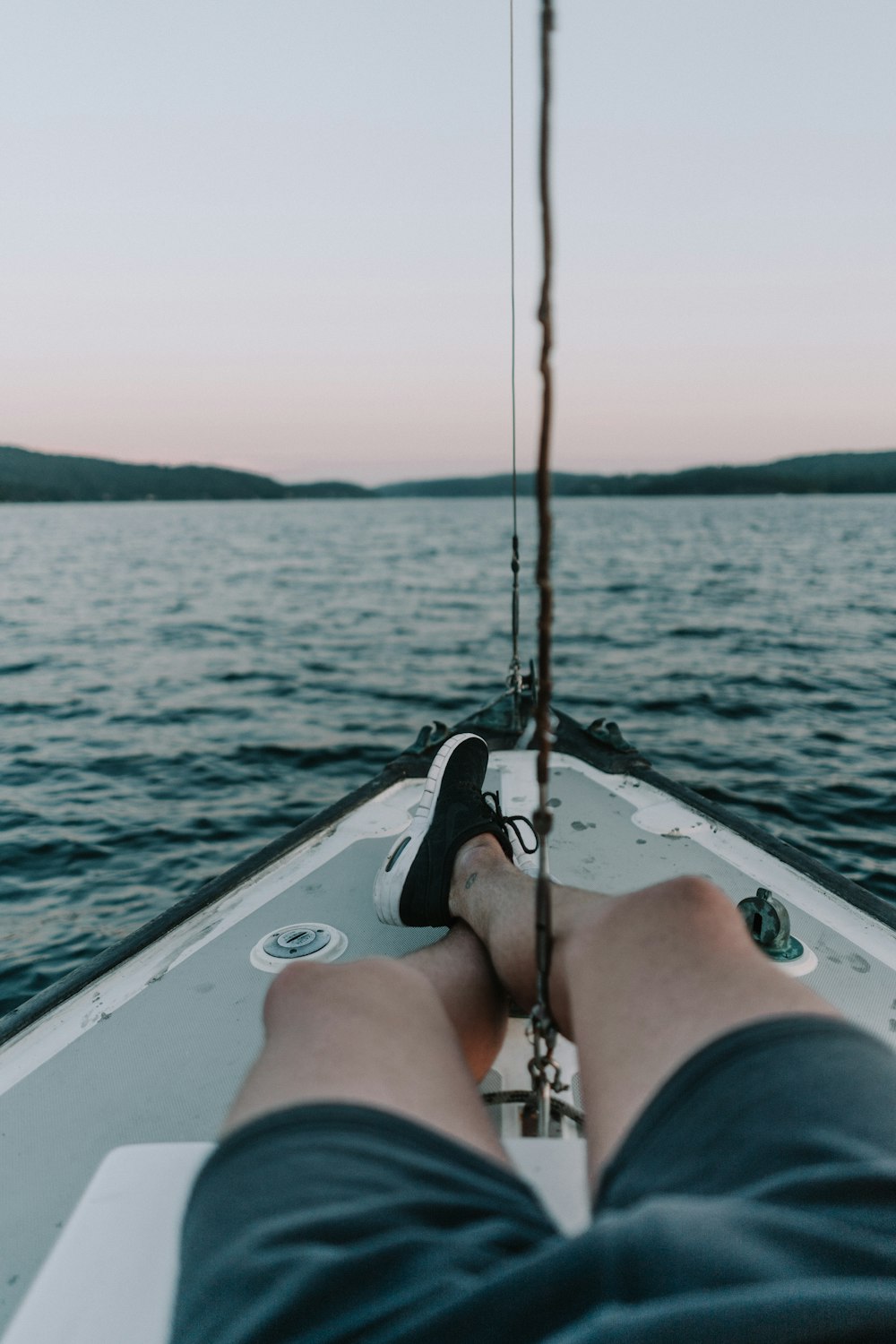 person sitting on white boat during daytime