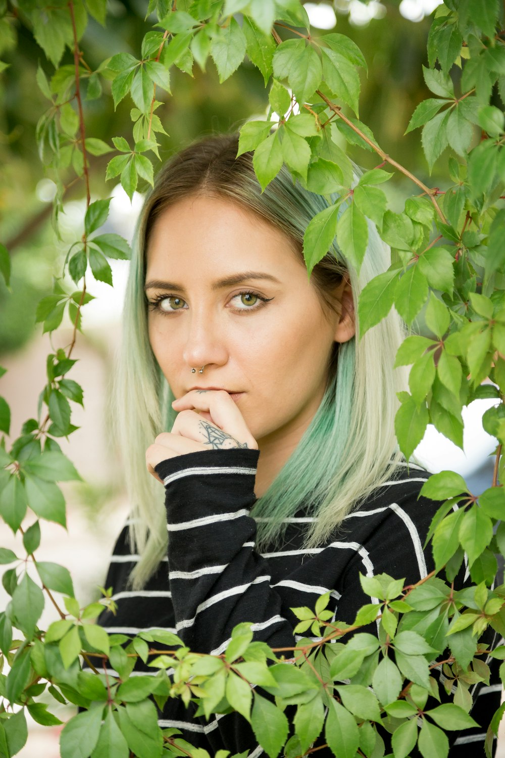 woman standing behind leaves