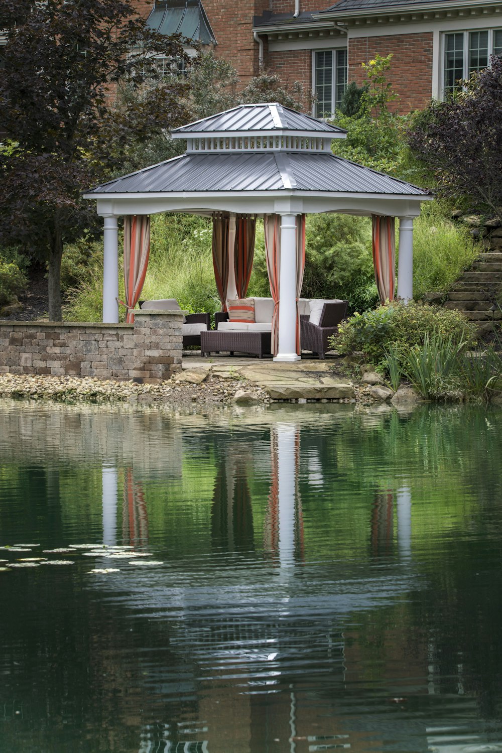 white sofa under gray and white gazebo