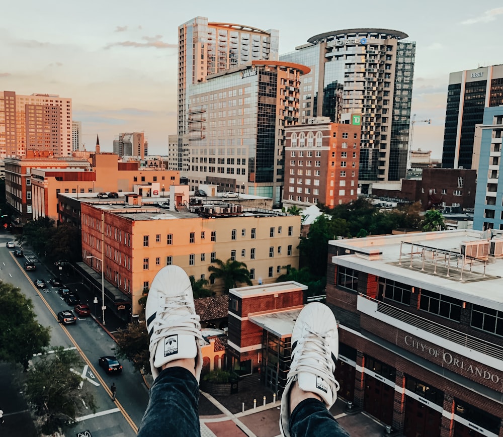 person sitting on high-rise building