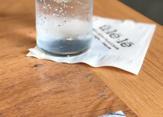 glass of water on brown table