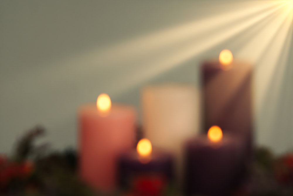 a group of lit candles sitting on top of a table