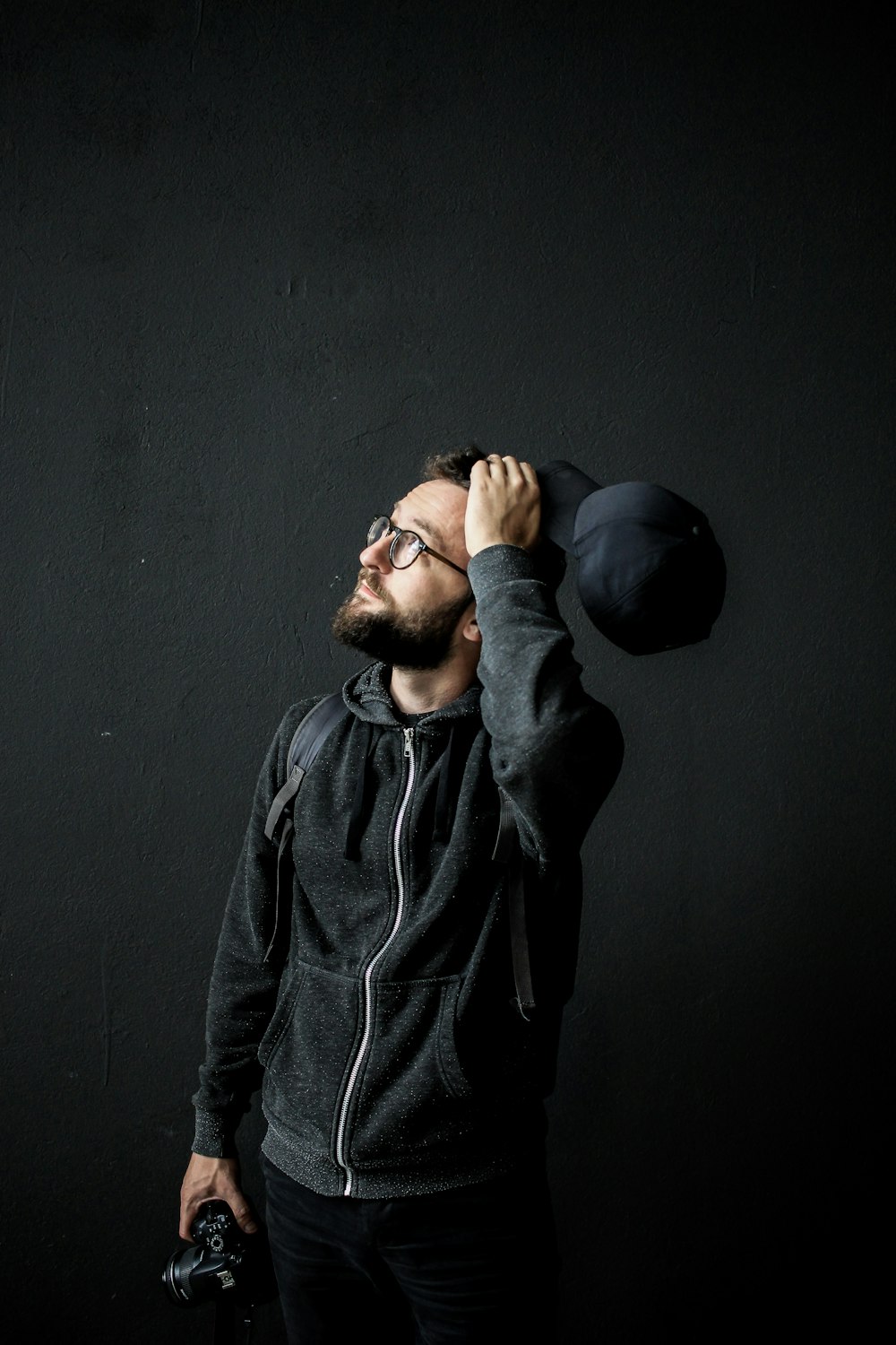 man looking up holding his hair