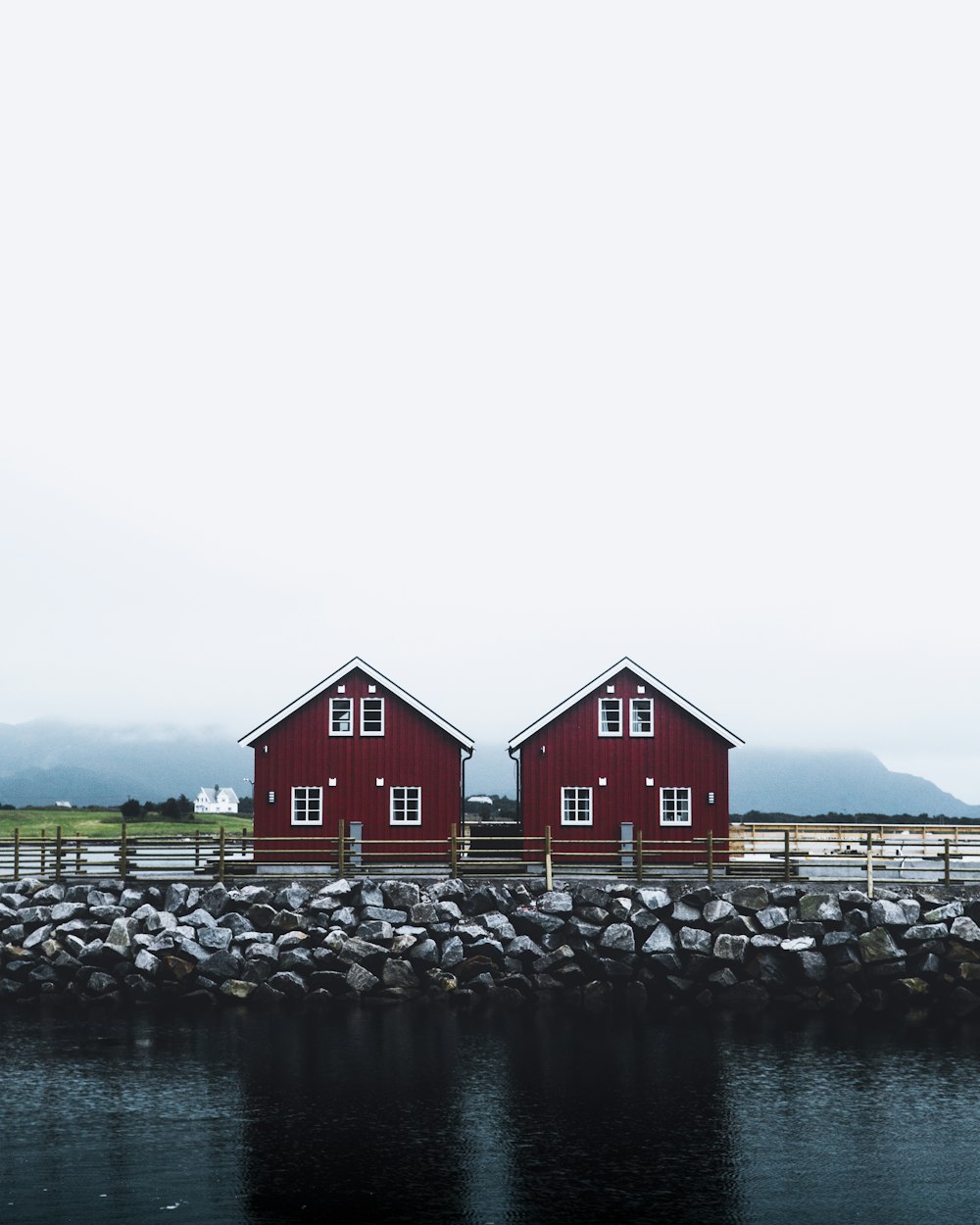 two maroon house near body of water